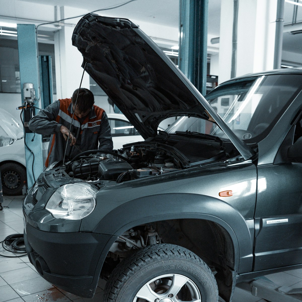 Mecanic verificând un motor în service